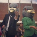 Men in suits wearing pigeon heads